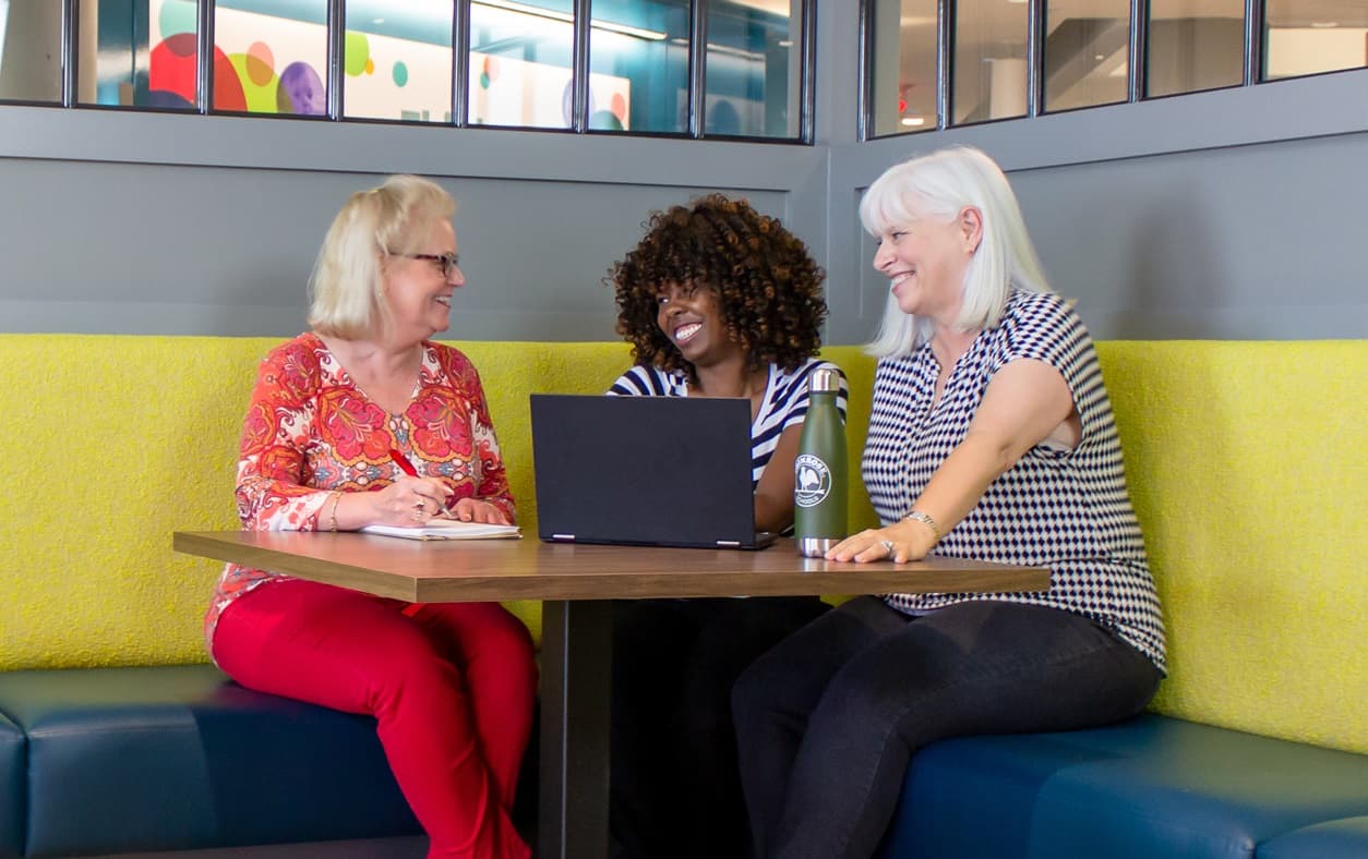 employees sitting around a table discussing work