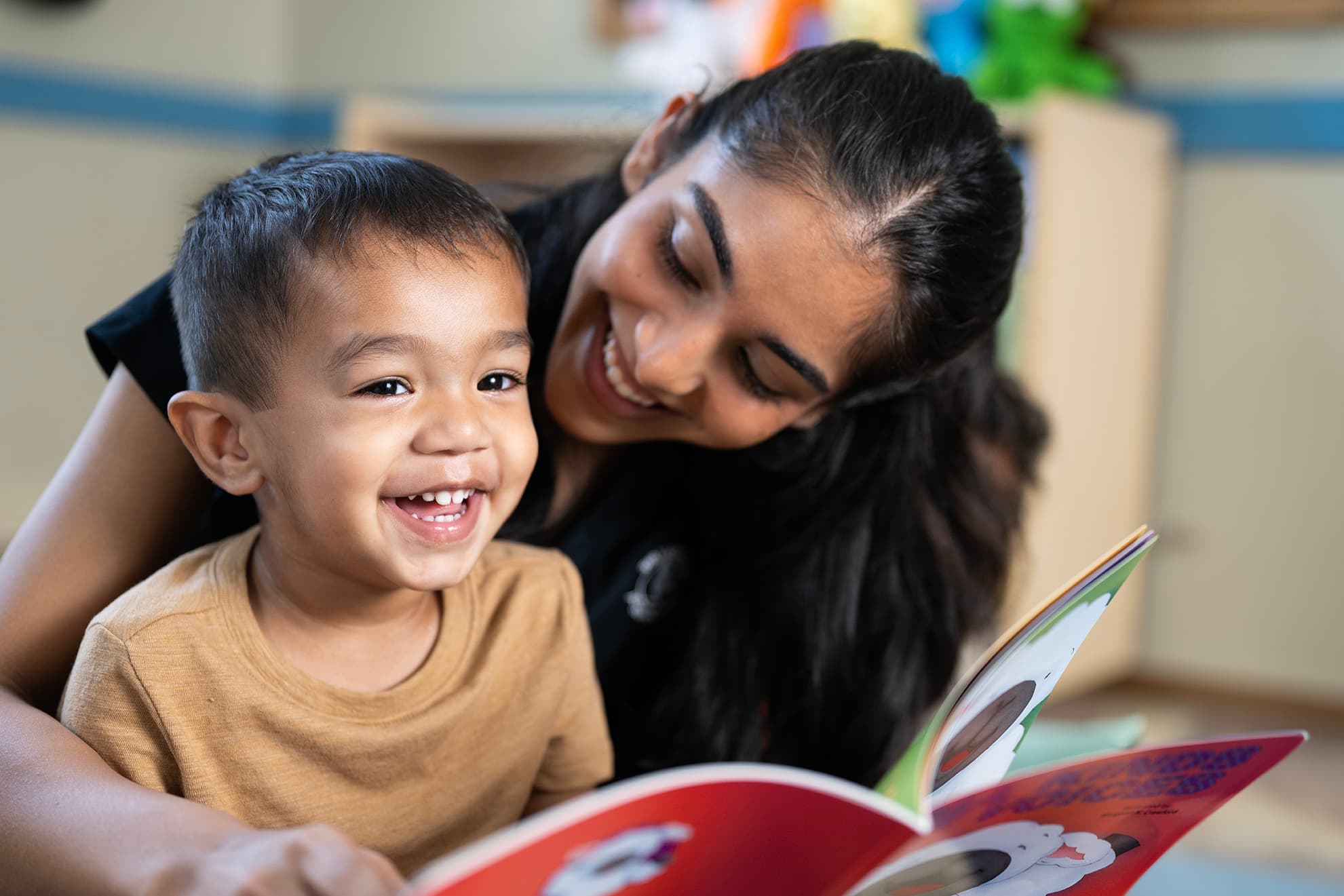toddler being read to by teacher