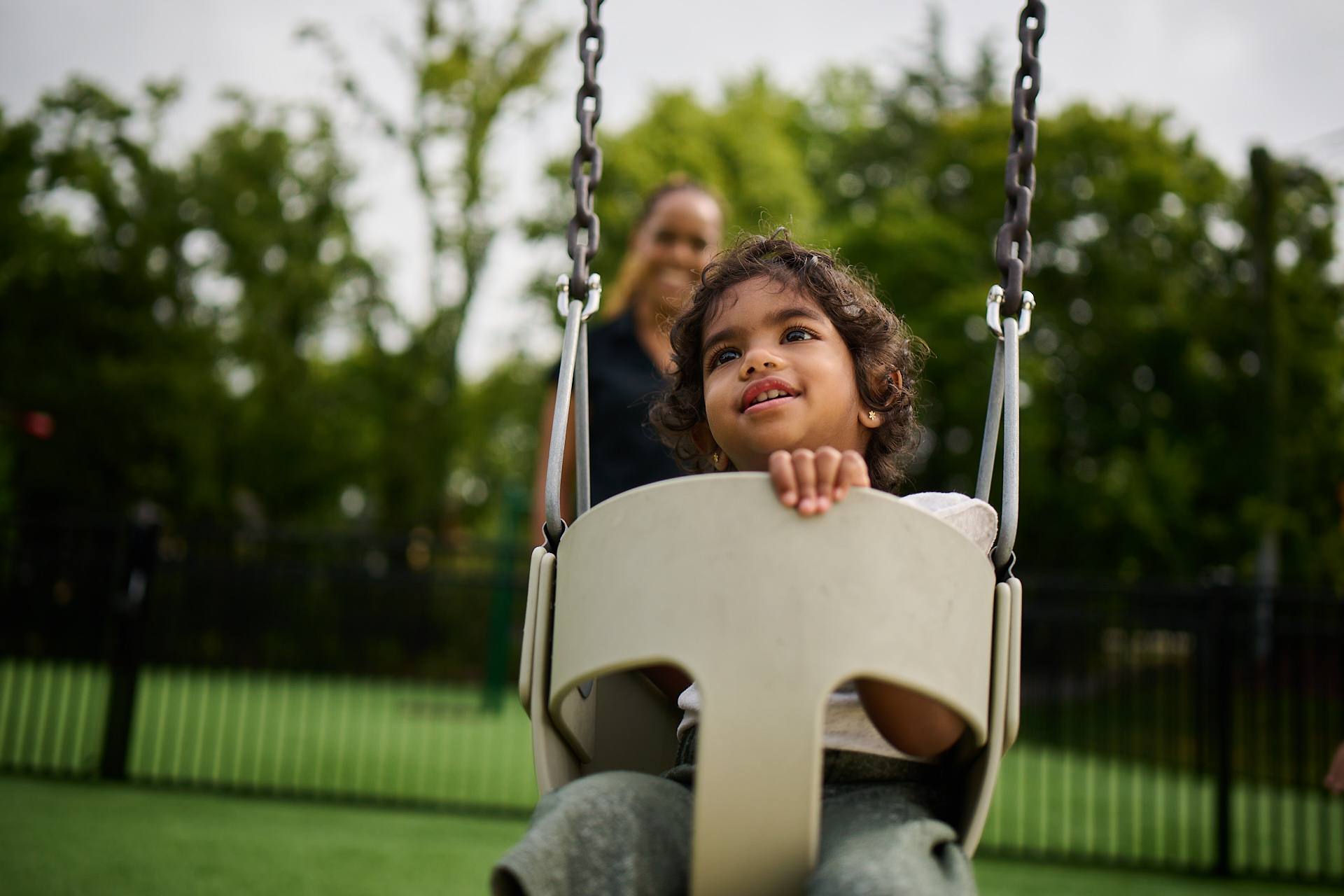 toddler swinging on the swing