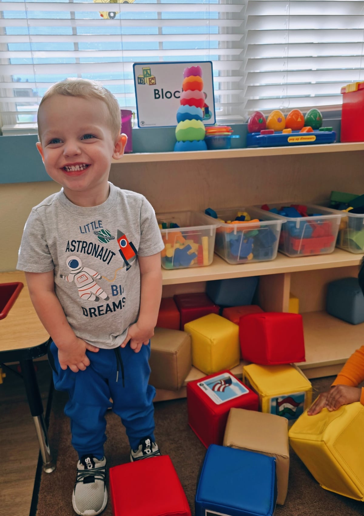 Toddler developing creativity and problem-solving skills in the blocks center at Primrose School in Keller, TX