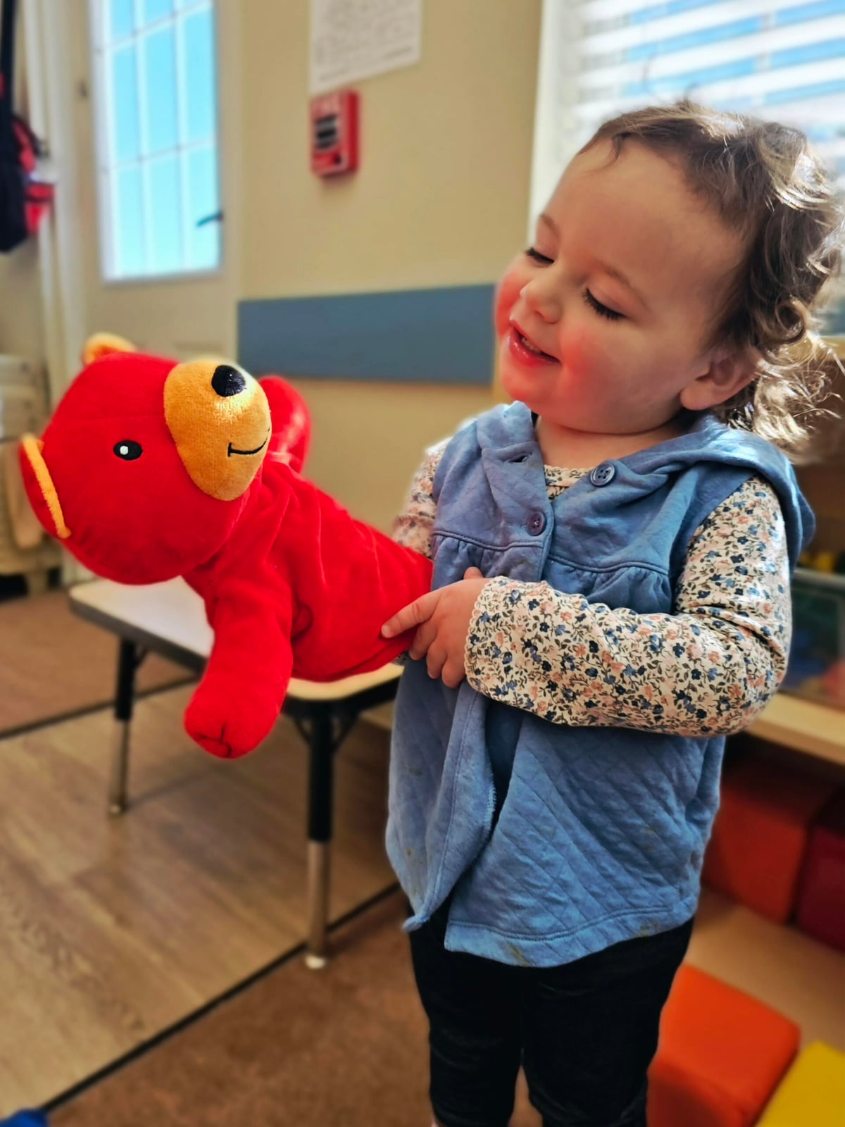 Little girl playing with a puppet at Primrose School at Heritage in Keller, TX, enjoying creative learning through play.