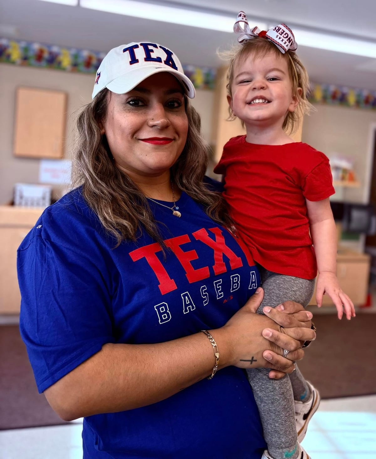 teacher with toddler early preschool child at a private childcare, daycare, preschool wearing texas rangers baseball shirts at best daycare, private preschool, toddler care near me, saginaw, fort worth, texas