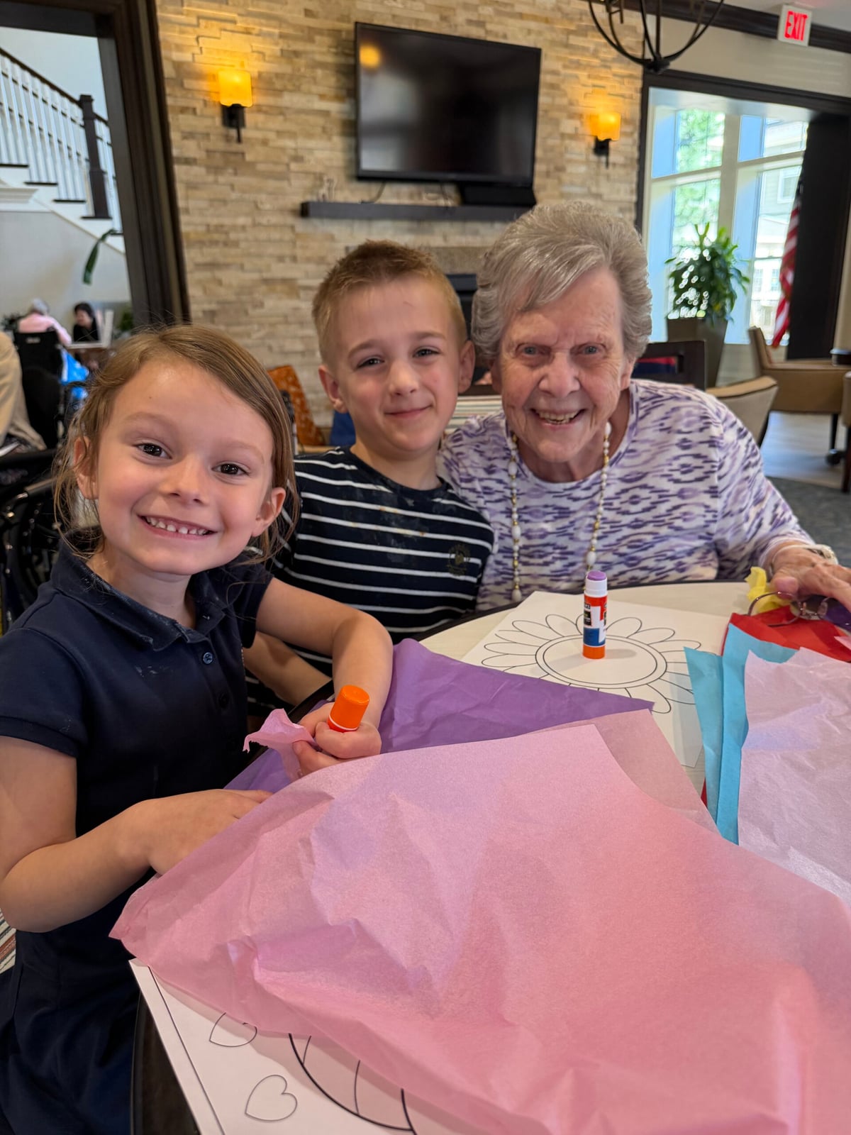 Primrose Burlington kindergarten students doing Earth Day crafts with residents at Stonebridge senior living community