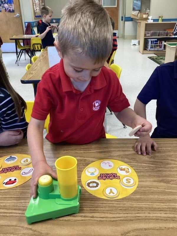 Boy wearing a Primrose uniform participating in the curriculum 