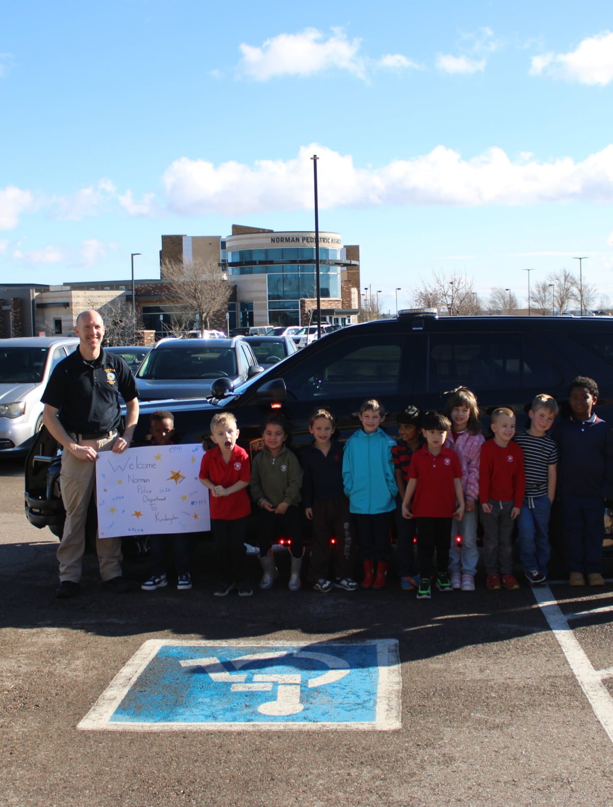 children lined up with police officer