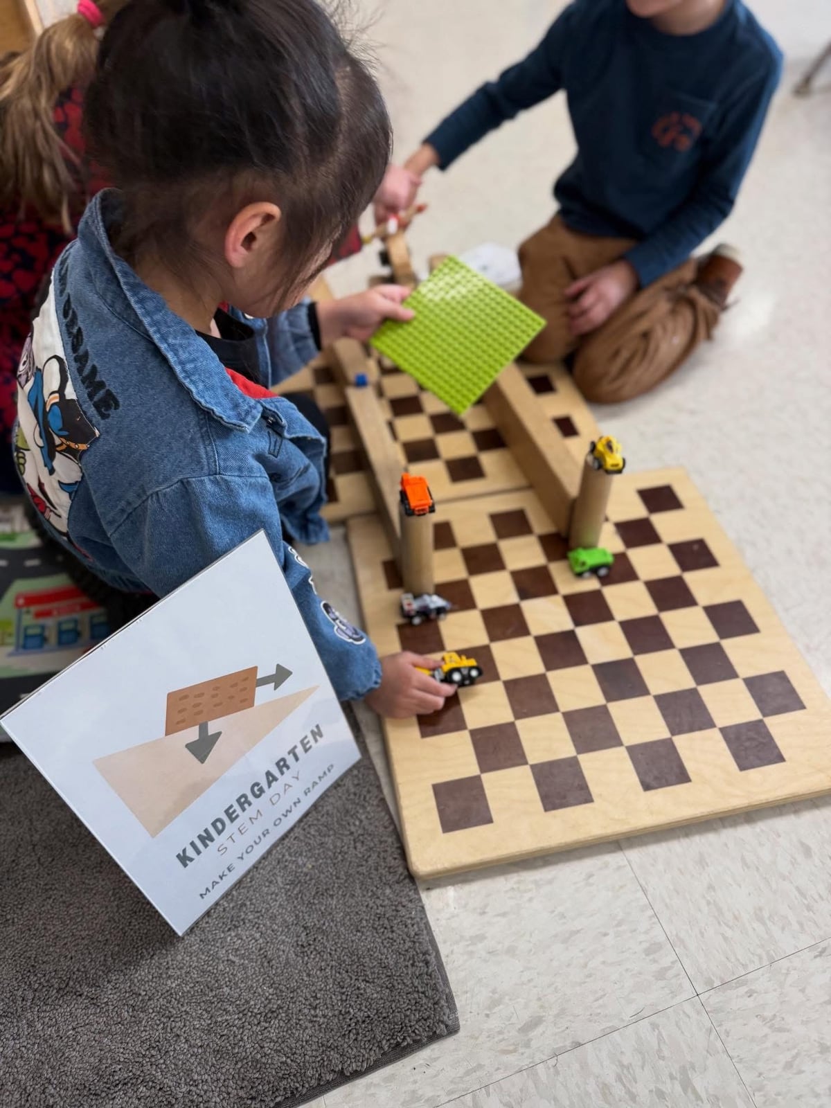 Kindergarten students building a ramp and track during STEM Day at Primrose School of Burlington