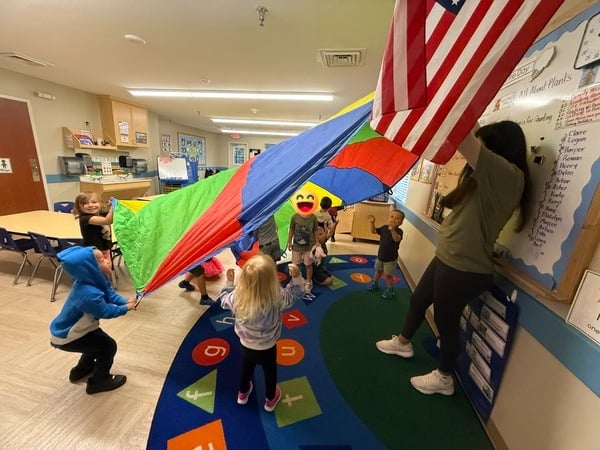 Parachute play in a classroom.