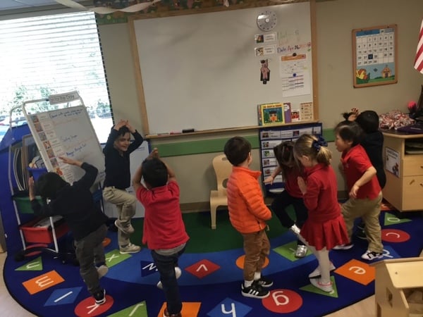 Preschool yoga practice in classroom in Bellevue, WA