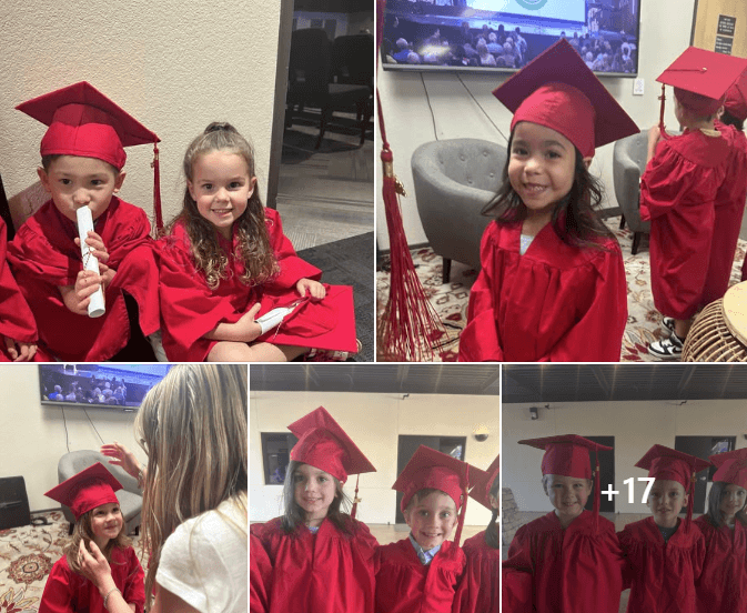 children smiling in red caps and gowns 