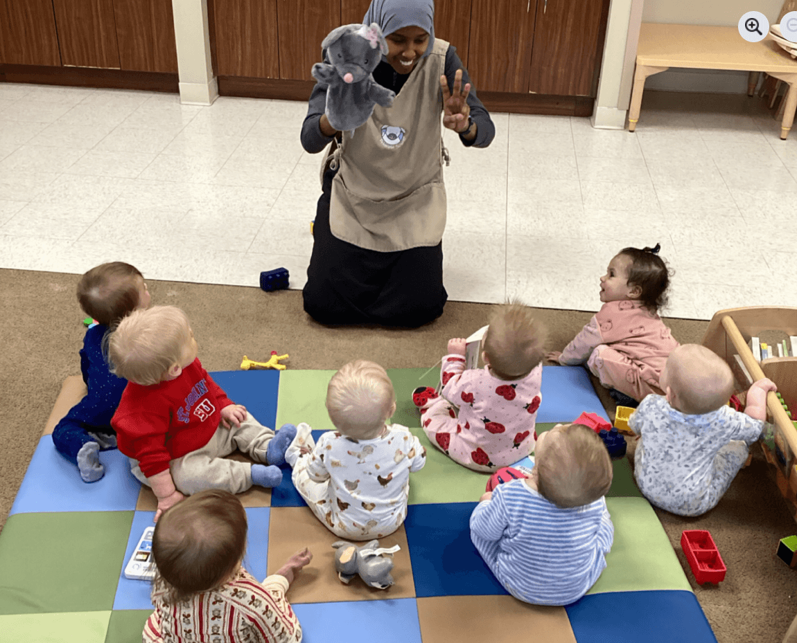 teacher showing puppet to infants