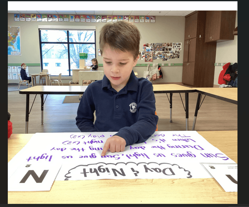 child looking at letters