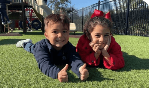 children holding up their work 