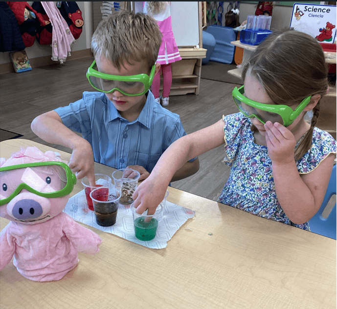 two Preschool children doing a science experiment 