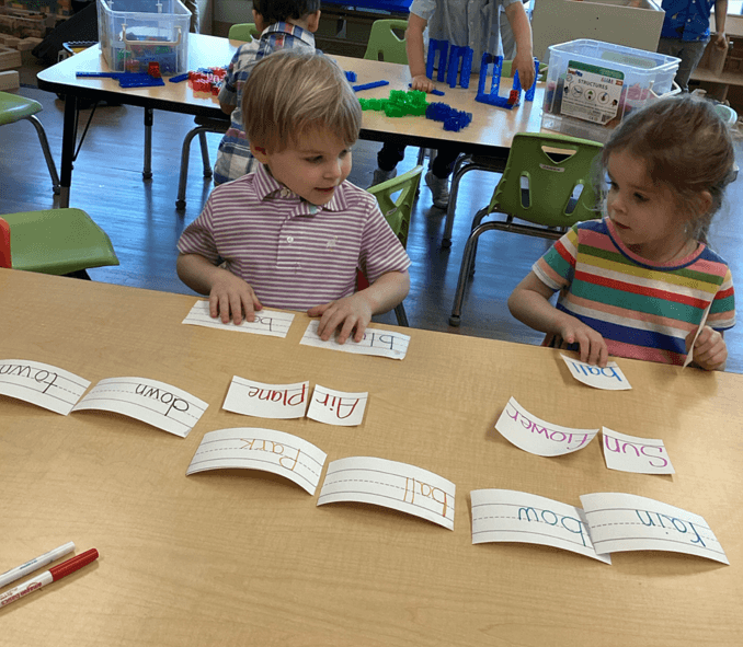 children looking at words