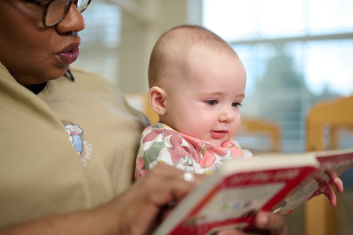 Teacher reading to an infant