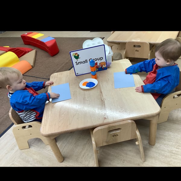 Toddlers sitting at a table