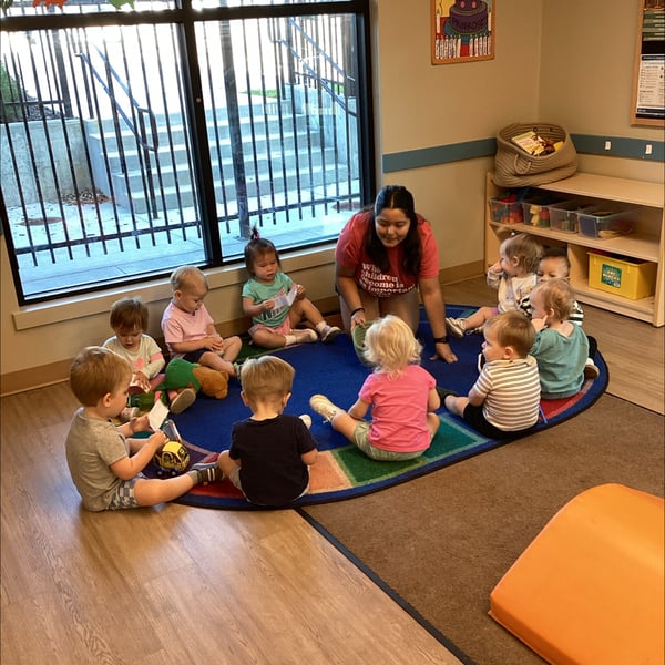 kids sitting in a semi circle for Circle Time
