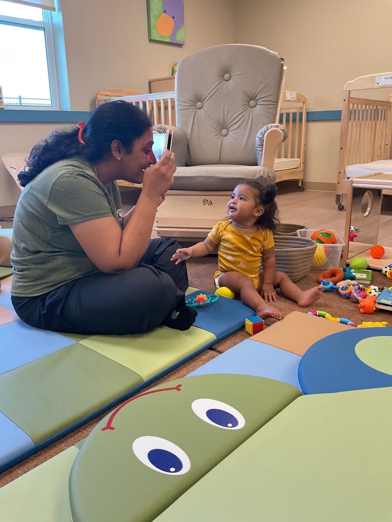teacher playing with infant