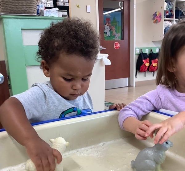 Toddlers participating in sensory play at Alliance daycare. 