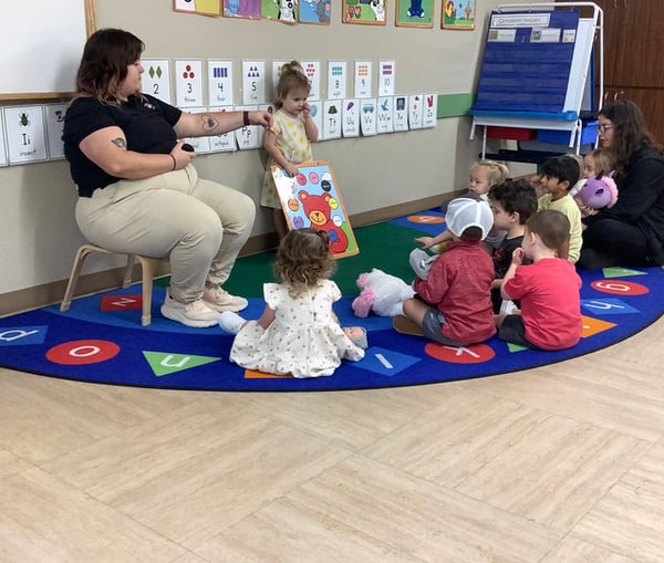 Children sitting in circle time going over colors