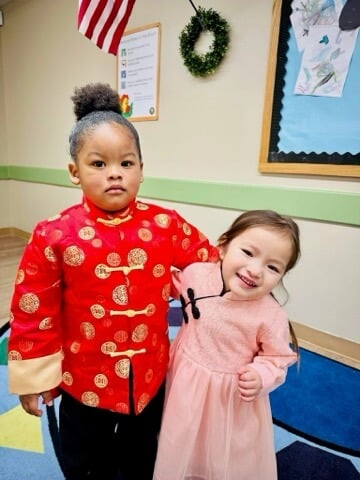Two children posing in traditional Lunar New Year clothing