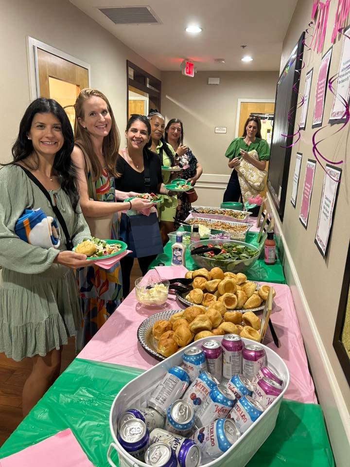 women lined up in front of food 