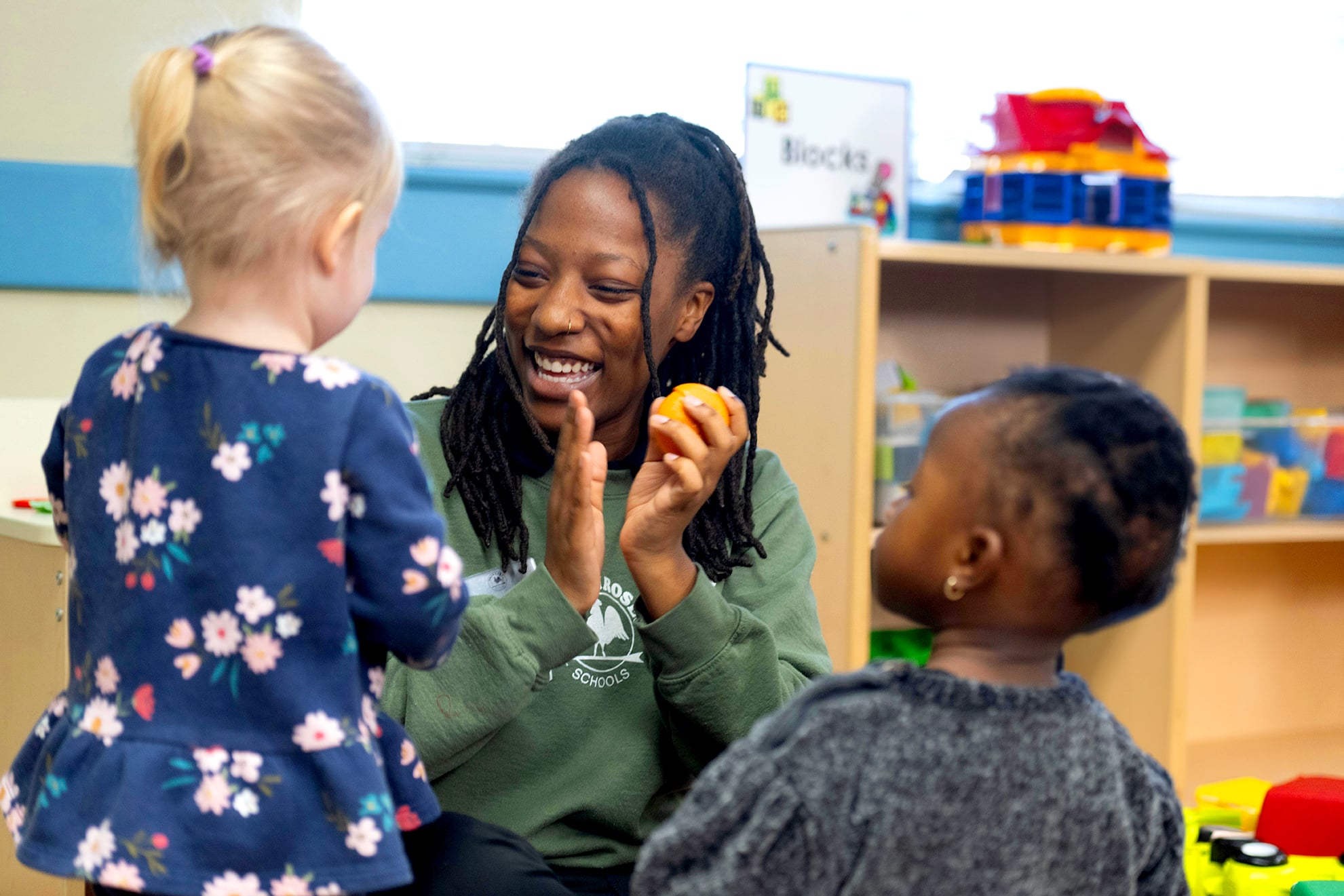 toddler teacher interacting with class