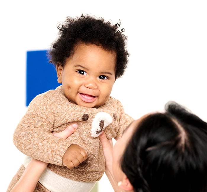 teacher holding up a baby