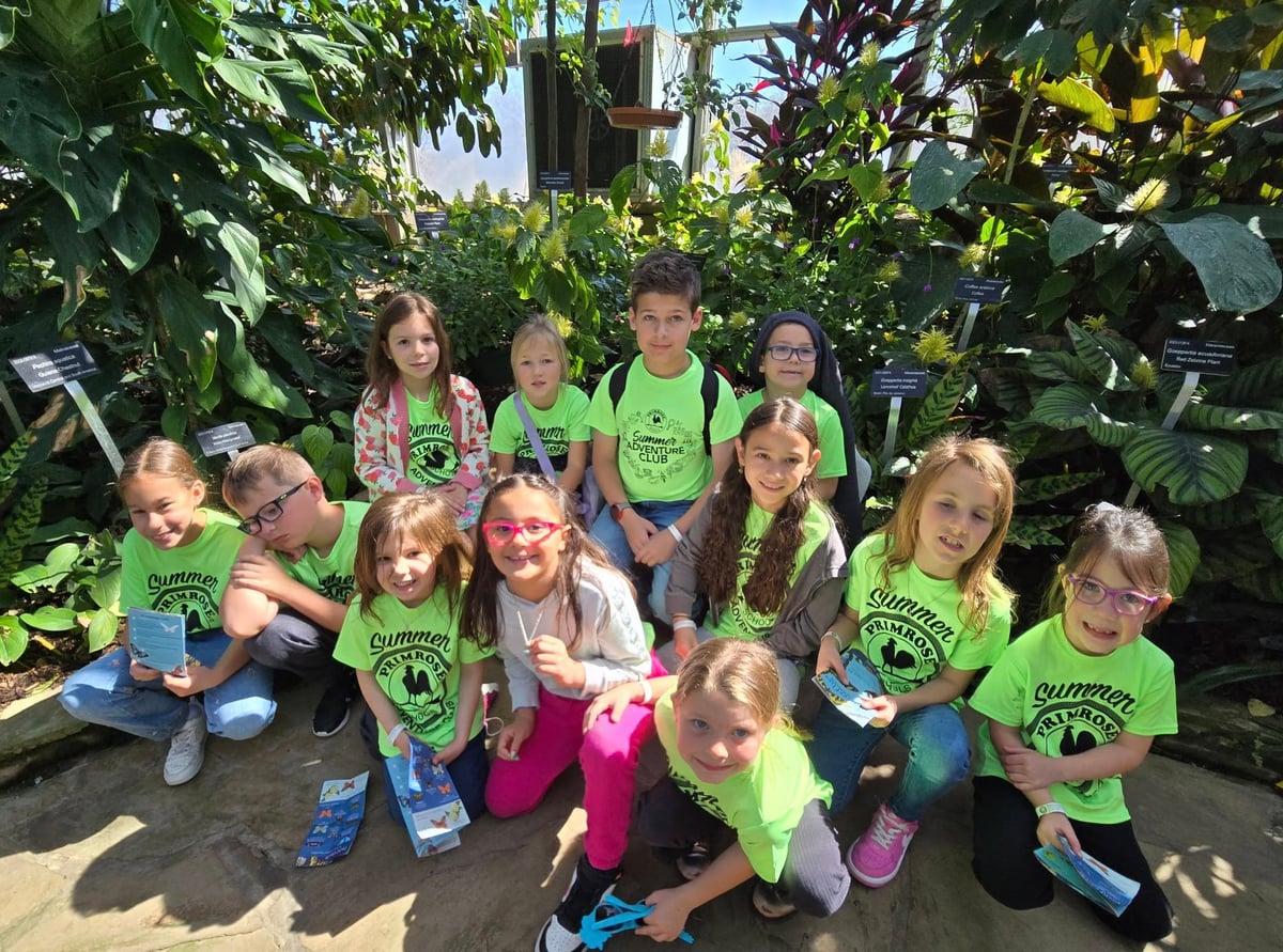 Summer camp group at zoo field trip observing animals to explore habitats and environmental science outdoors