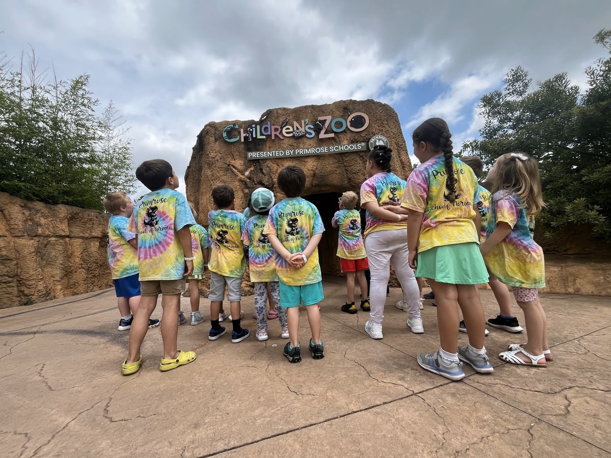 Children standing in front of the Primrose petting zoo