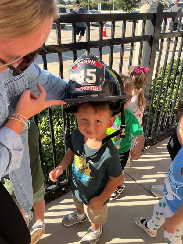 Happy Toddler wearing a fire man hat