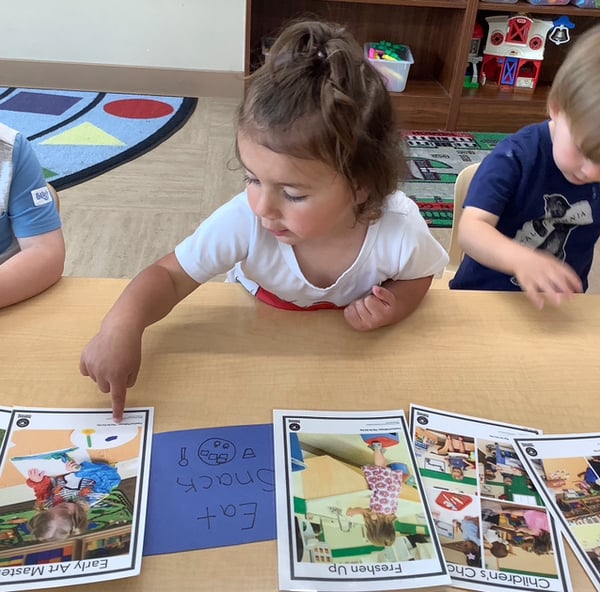 Preschool teacher leading a small group learning activity