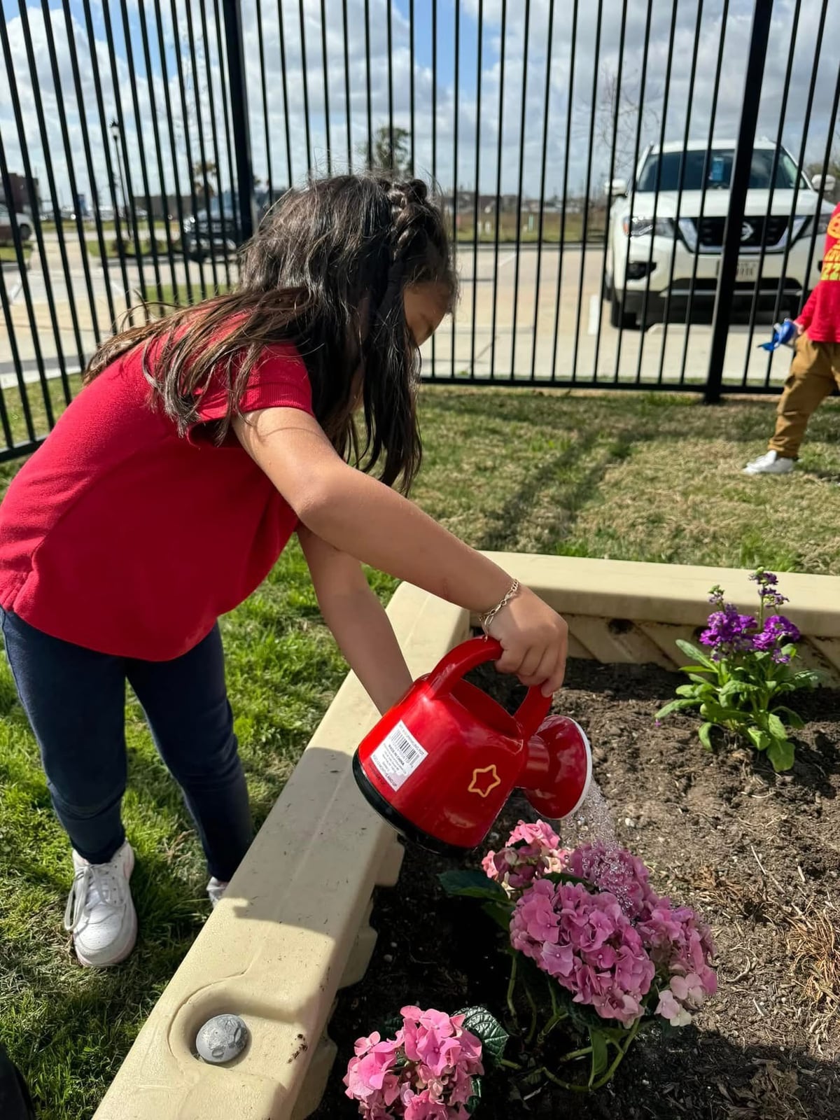 child gardening, watering flowers, sensory play, education