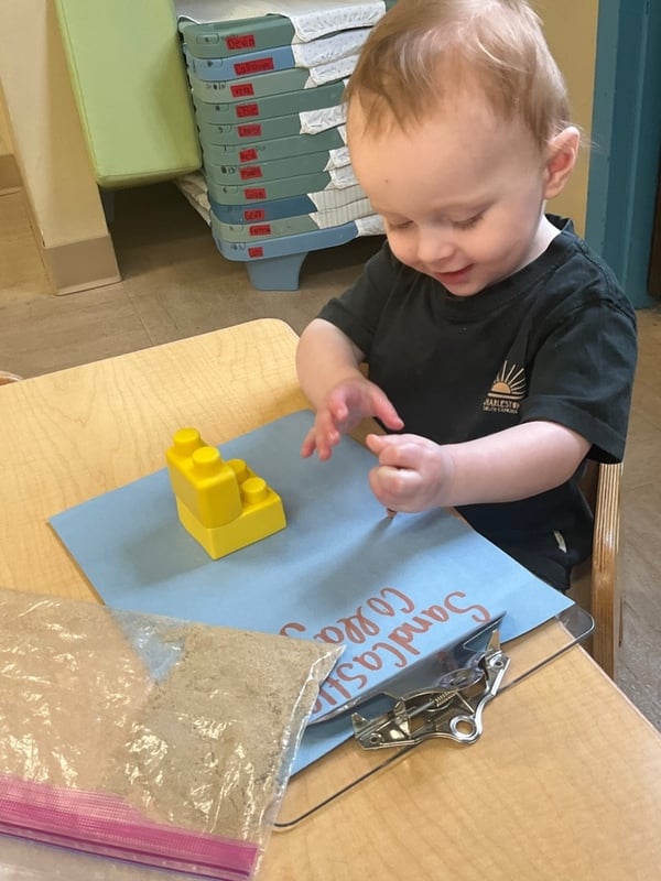 child exploring sand