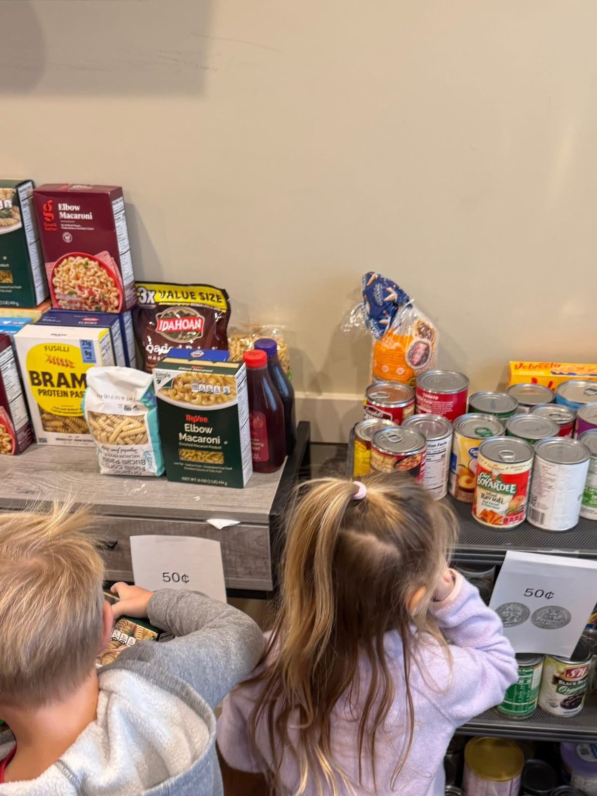 Students purchasing food for our Caring and Giving food drive, we collected 693 items