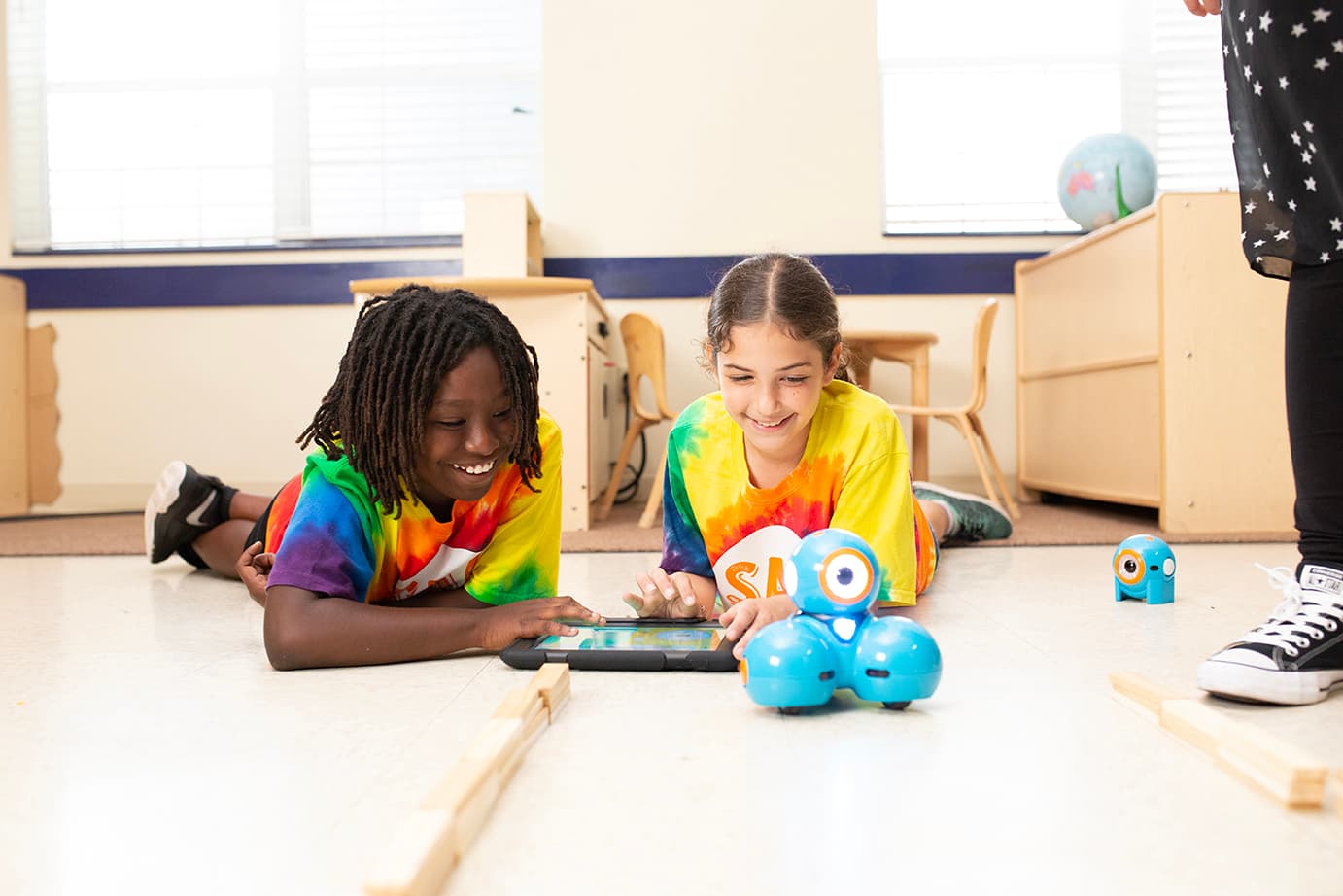 two children playing with robot