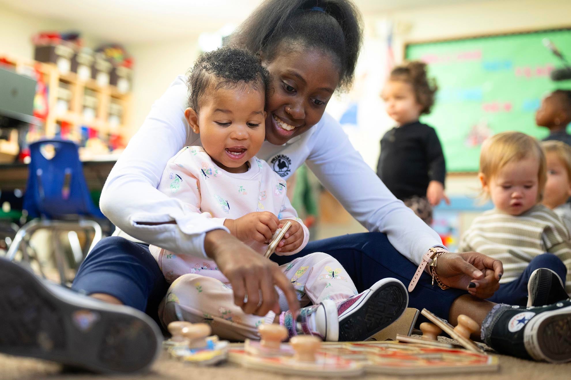 teacher playing with toddler