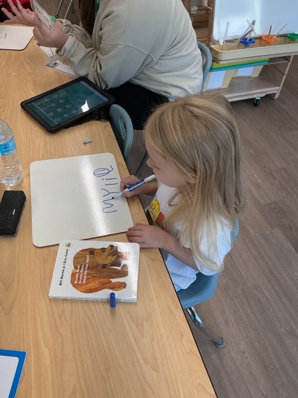 Girl writing her name