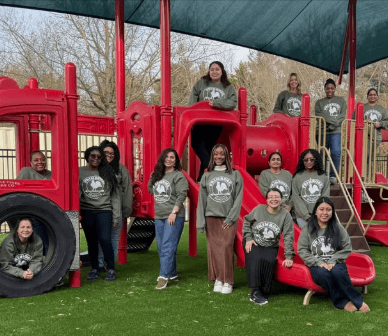 teachers posing on firetruck playground